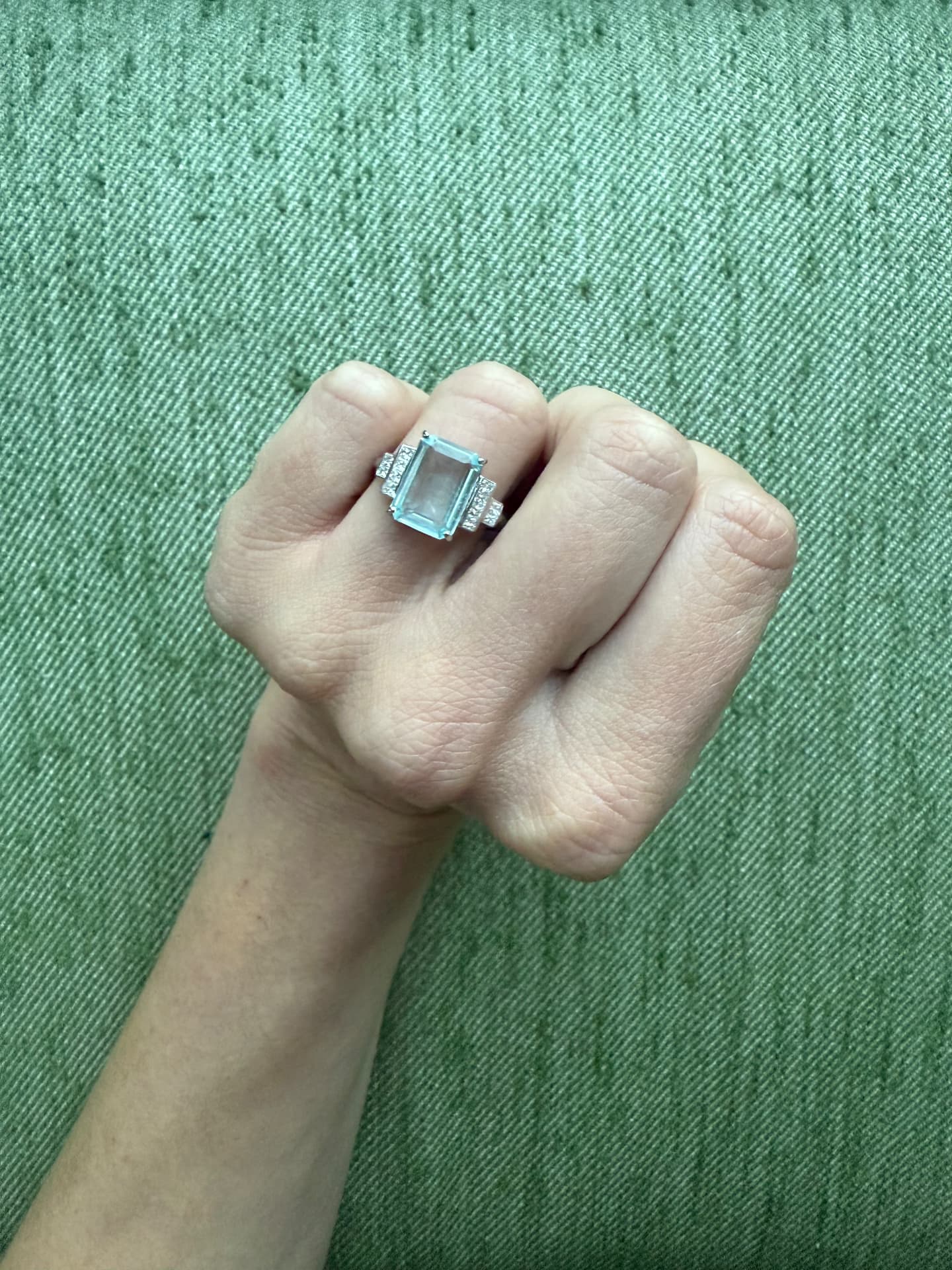 Aquamarine and diamond Art Deco style ring worn on a hand