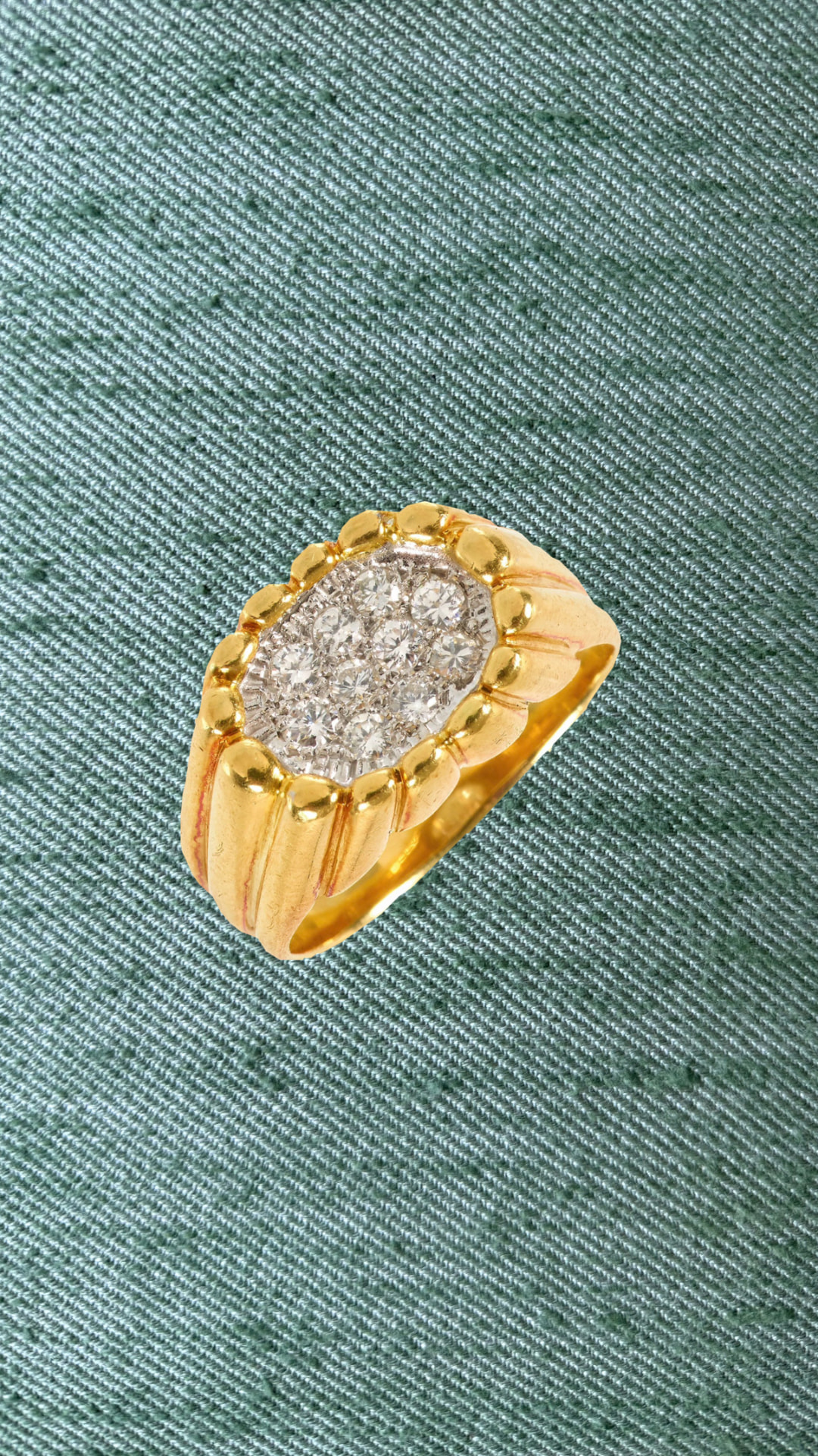 Gold and diamond bombe cluster ring on green silk