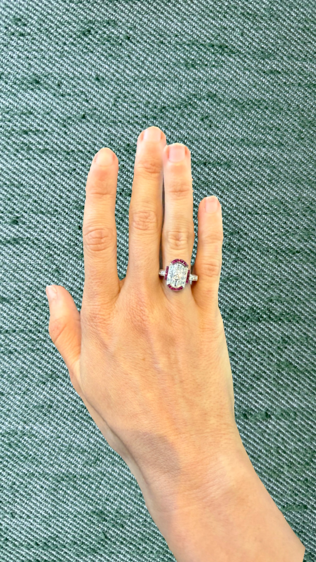 Art Deco ruby and diamond plaque ring worn on a hand