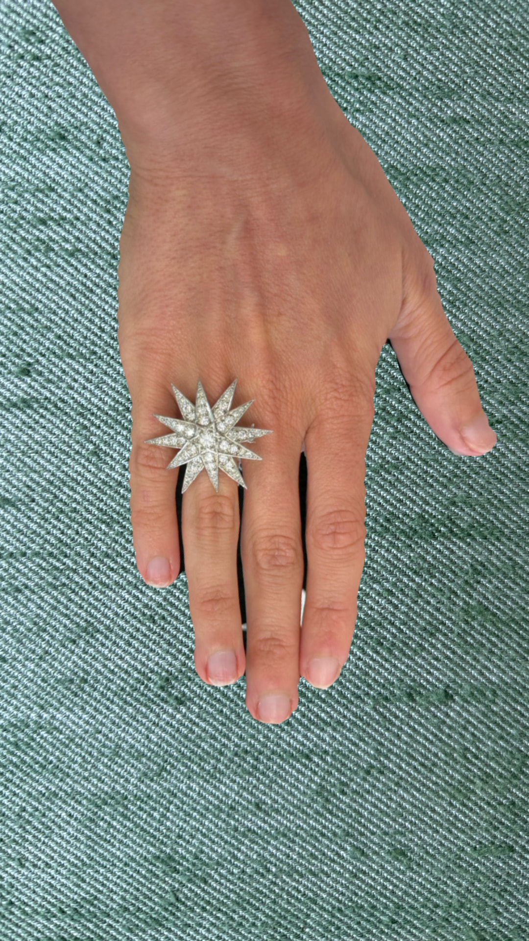 Diamond pavé starburst cocktail ring worn on a hand