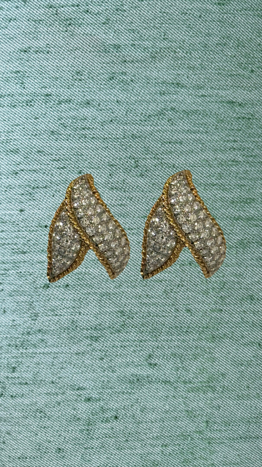 Vintage diamond leaf earrings on green silk