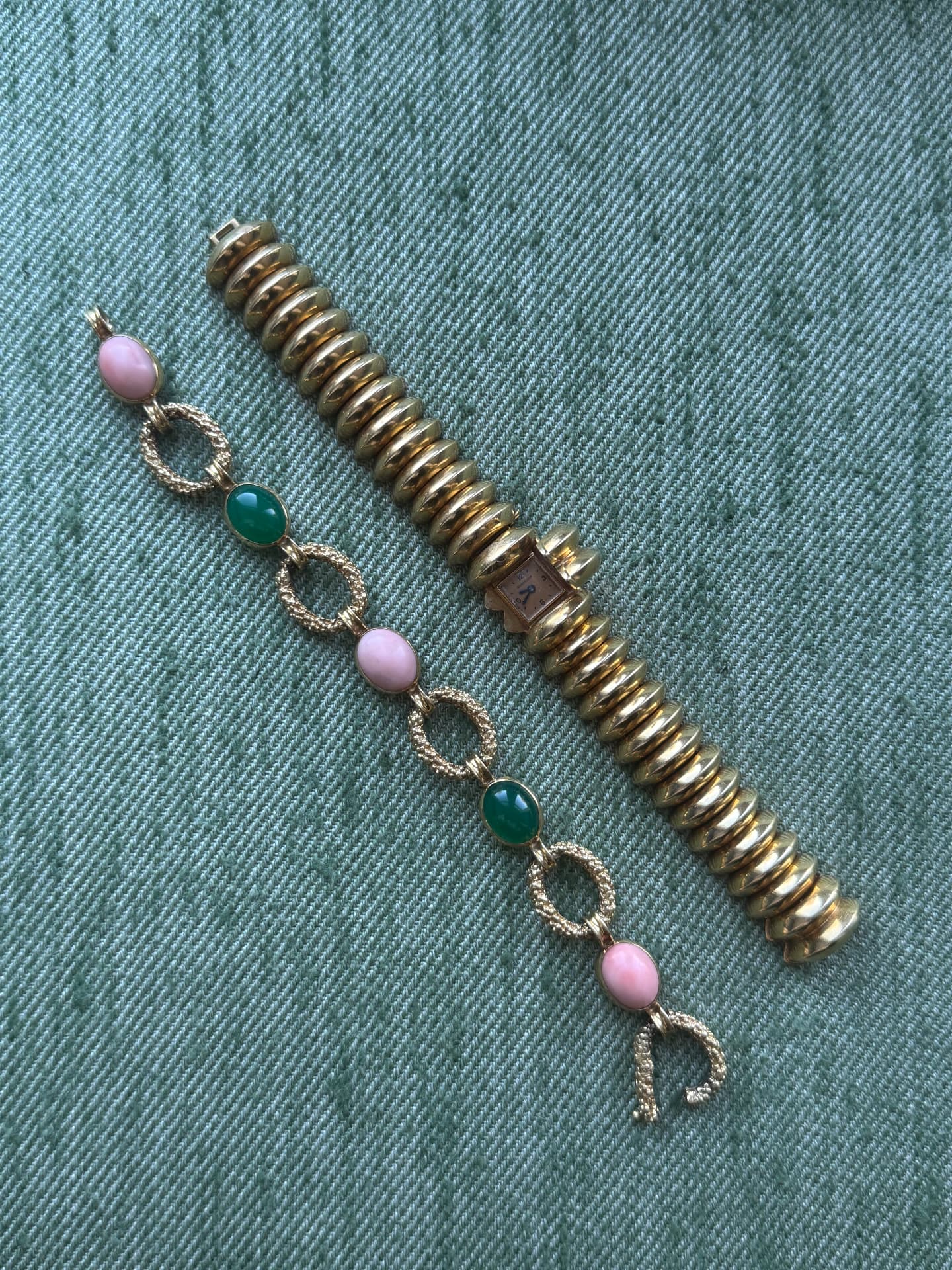 Gold coral and chrysoprase cabochon bracelet beside a gold cocktail watch